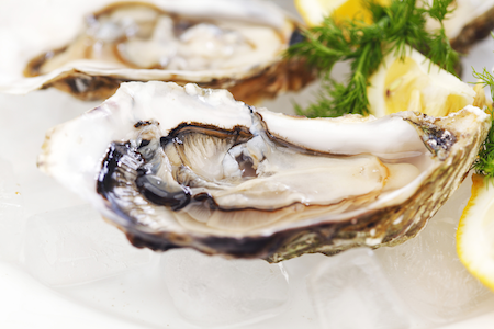 oysters and lemon on a white surface
