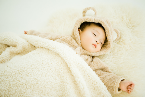 baby sleeping in a fuzzy bear costume