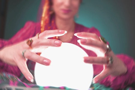 fortune teller with her hands around a crystal ball