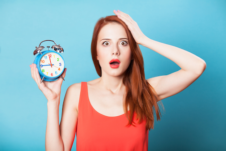 confused woman holding a clock